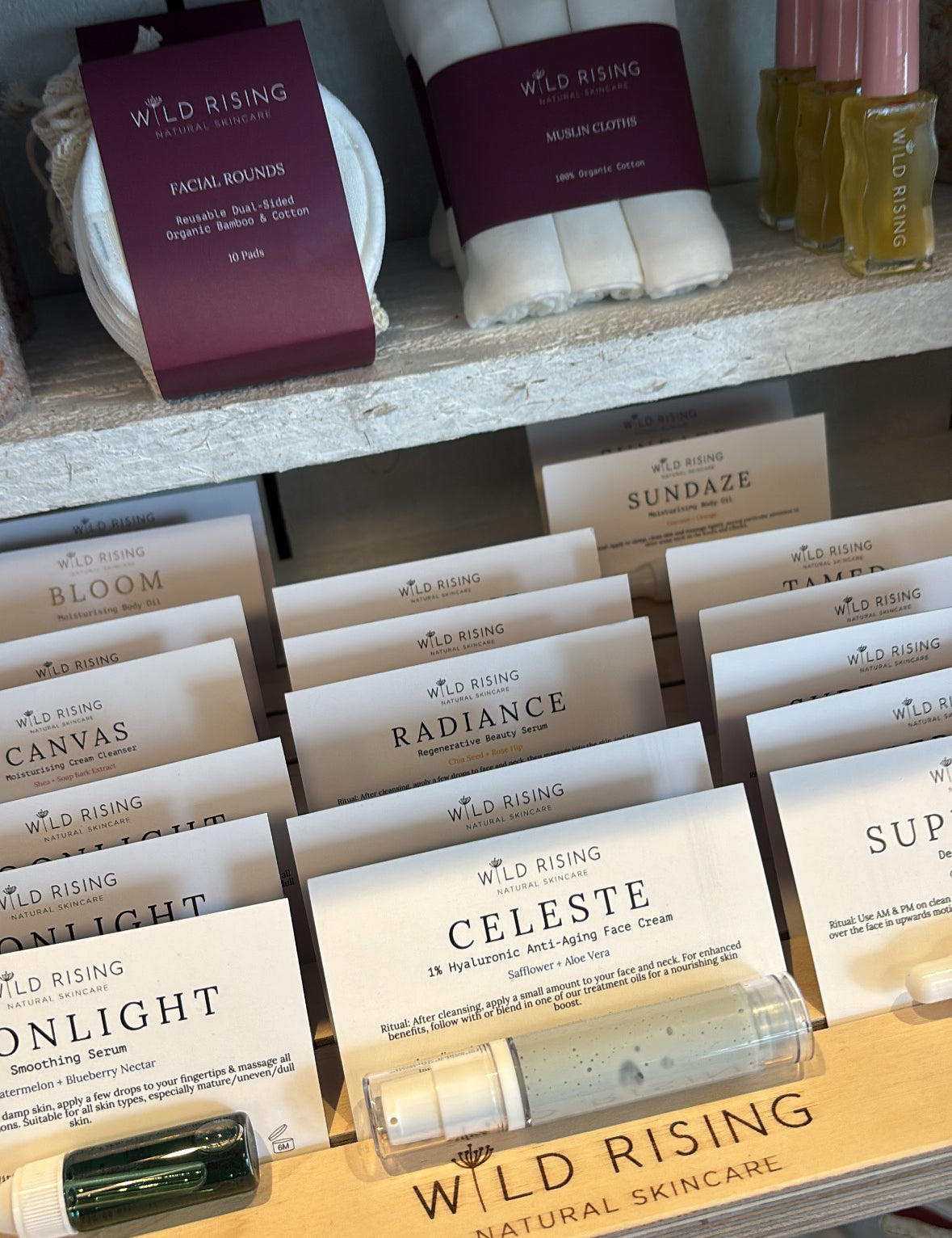 Display of Wild Rising natural skincare products in a store setting.