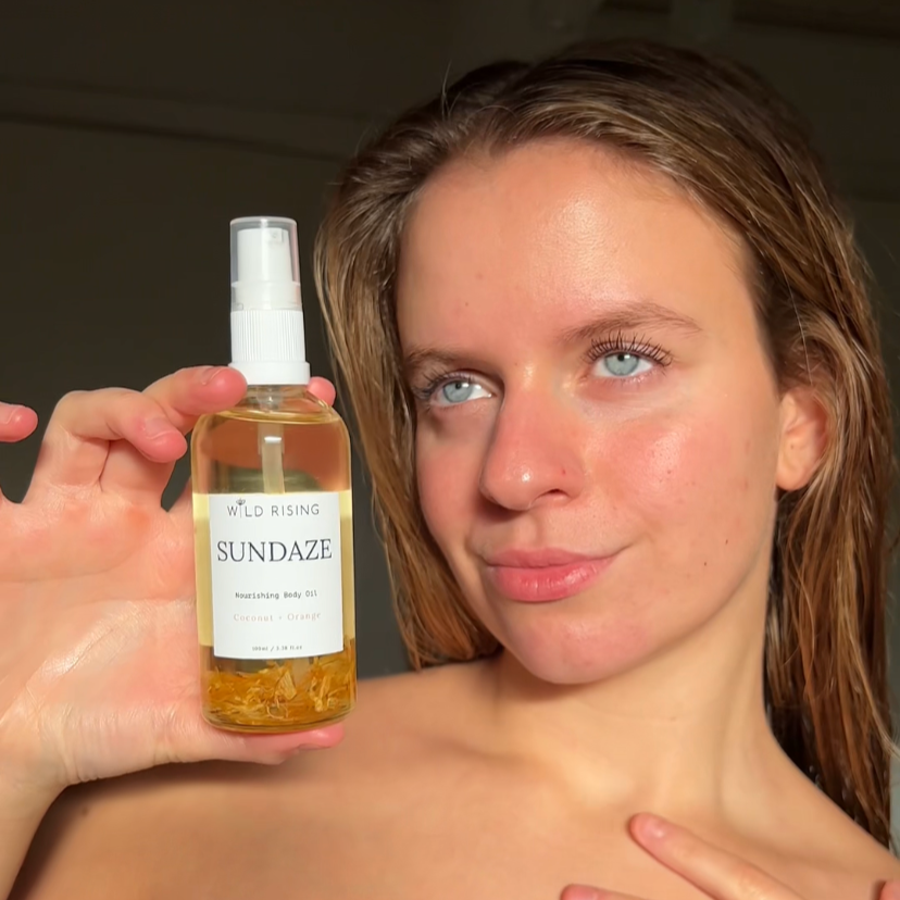 customer holding coconut and orange body oil