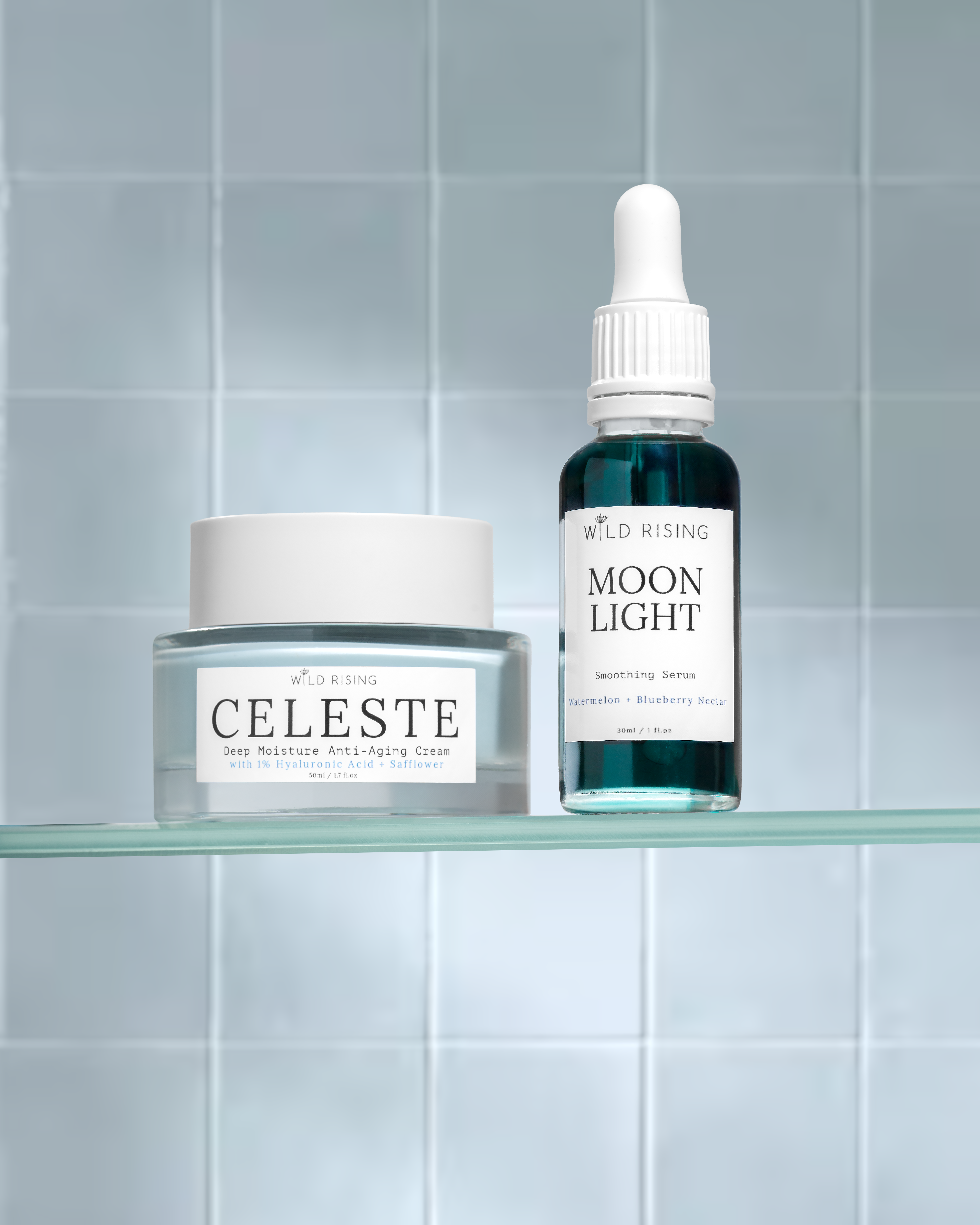 Two skincare products, 'Celeste' and 'Moon Light', on a glass shelf against a tiled wall.