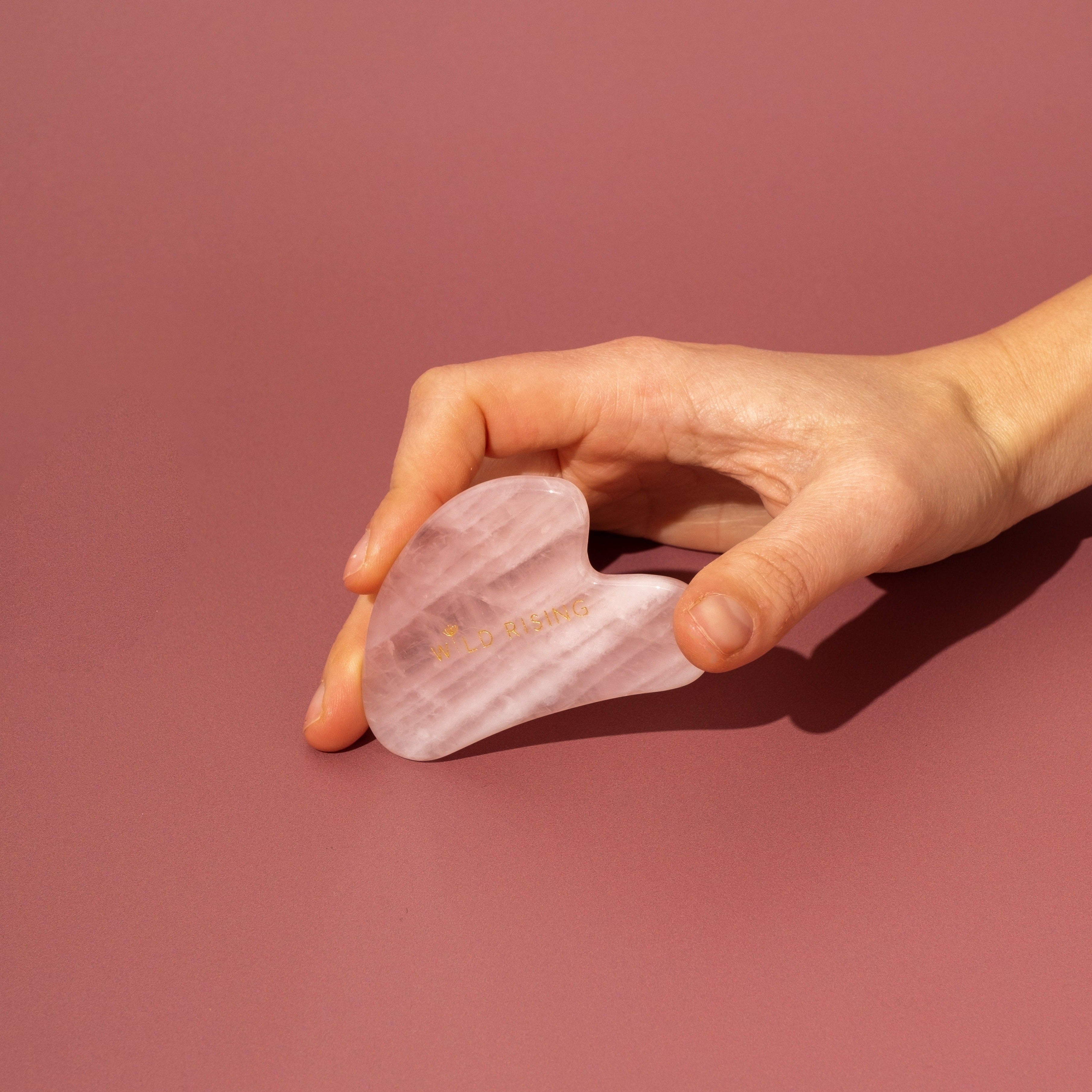 rose quartz gua sha wild rising model holding
