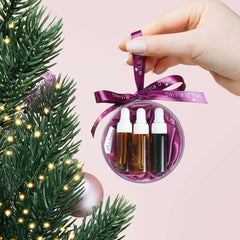 Decorative ornament with mini face oil bottles on a Christmas tree