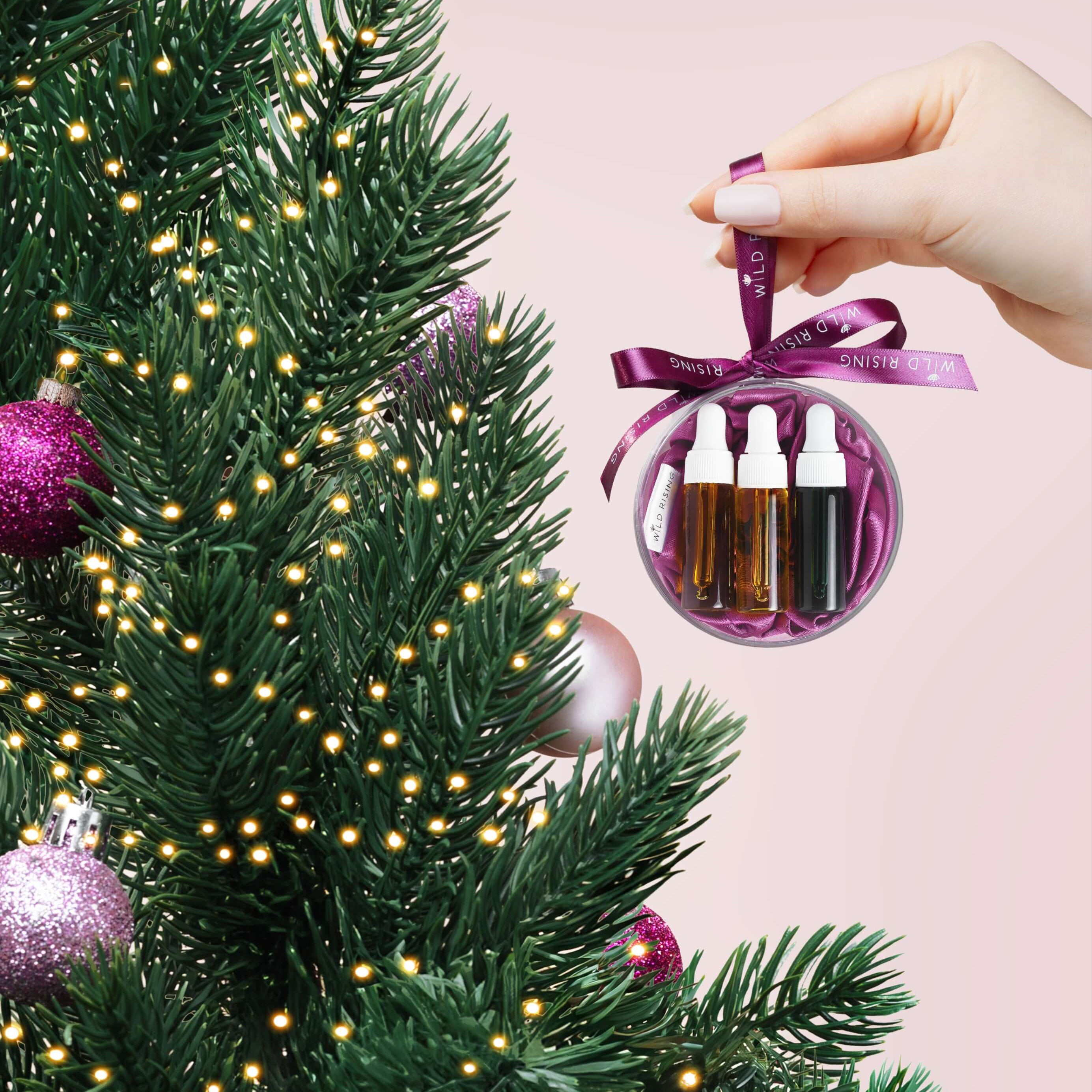 Decorative ornament with mini face oil bottles on a Christmas tree
