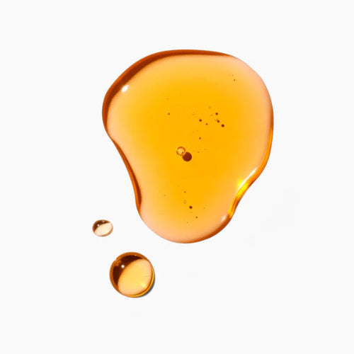 Amber-colored liquid droplet on a white background