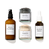 four glass skincare products on white background