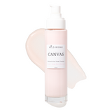 A bottle of Wild Rising Canvas Moisturizing Cream Cleanser with a white pump dispenser, set against a clean white background with a pale pink cream smear behind it.