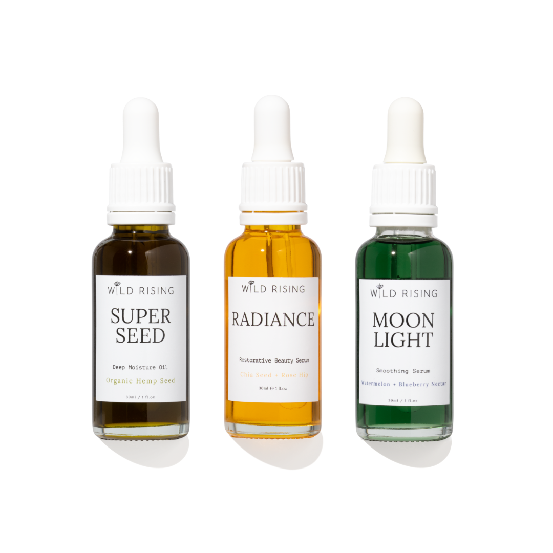 three glass bottles with face oils