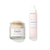 Two skincare products from Wild Rising on a white background: a clear glass jar of Naked Foaming Clay + Orange Peel mask powder with beige powder visible, and a tall pale pink pump bottle of Canvas Moisturizing Cream Compound.