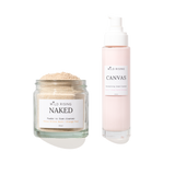 Two skincare products from Wild Rising on a white background: a clear glass jar of Naked Powder to Foam Cleaner with beige powder, and a pale pink pump bottle of Canvas Cream Cleaner.