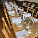 long wooden table set up for a skincare event