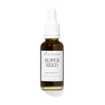 A 30ml glass dropper bottle of Wild Rising Super Seed Deep Moisture Oil, featuring an amber-colored bottle, a white dropper cap, and a white label with black text.