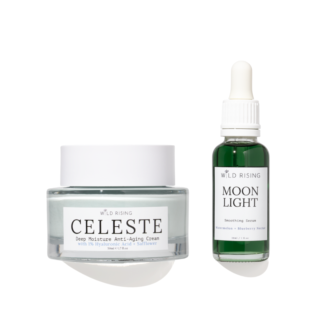 Two skincare products from Wild Rising on a white background: a Clear Jelly jar of Celeste Deep Moisture Anti-Aging Cream and a green bottle of Moon Light Smoothing Serum.