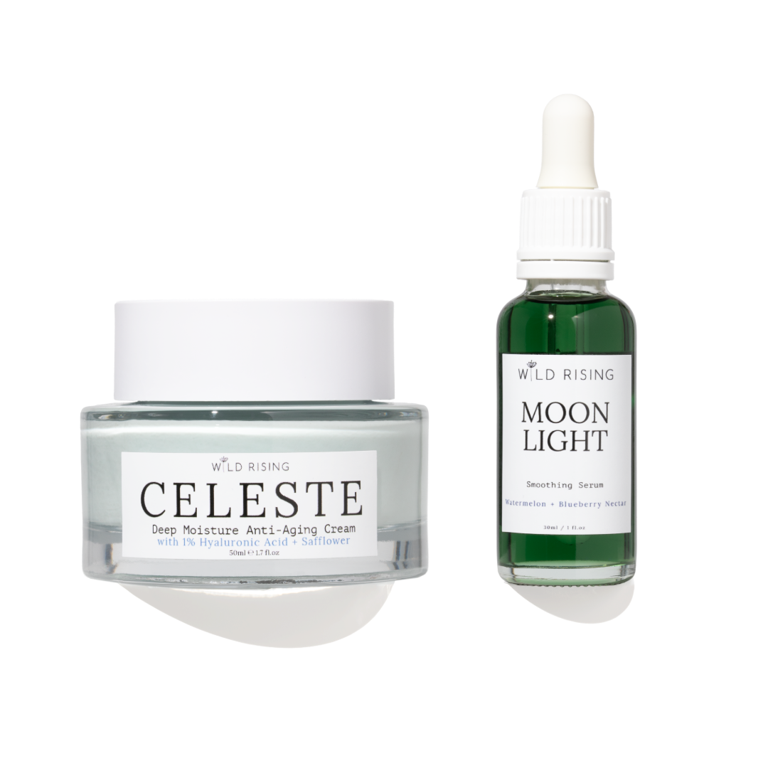 Two skincare products from Wild Rising on a white background: a Clear Jelly jar of Celeste Deep Moisture Anti-Aging Cream and a green bottle of Moon Light Smoothing Serum.