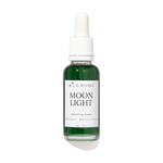 A bottle of Wild Rising Moon Light Smoothing Serum with a white dropper cap and a white label, containing a dark green liquid, set against a plain white background with a soft shadow.