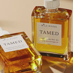 two square hair oil bottles 
