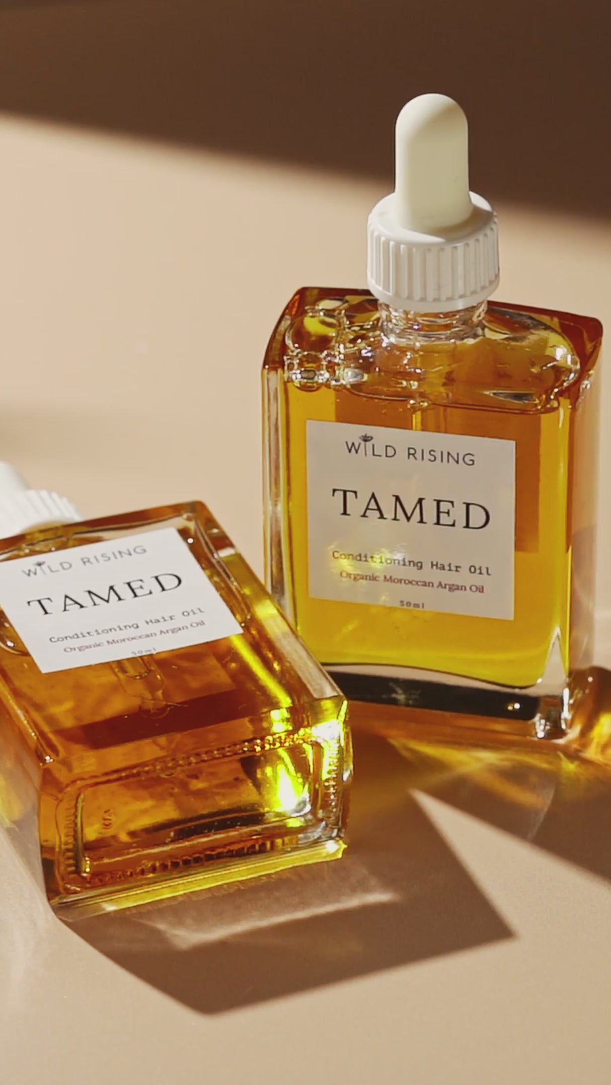two square hair oil bottles 