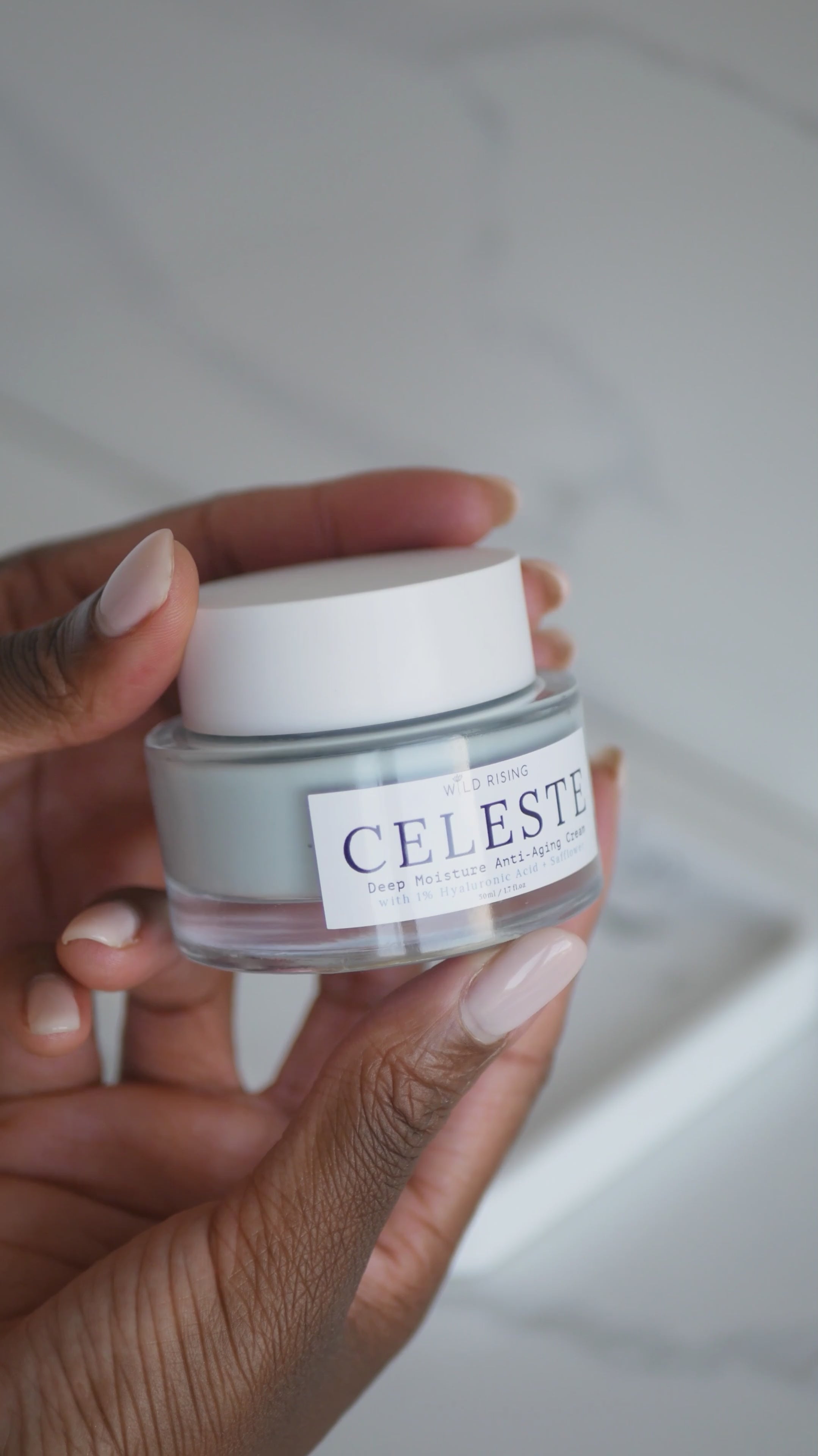 jar of face cream being held and used