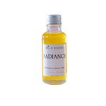 A small glass bottle of Wild Rising Radiance restorative beauty serum with a silver cap, filled with yellow liquid, on a white background.