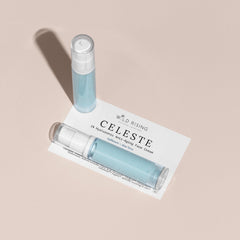 Two small blue bottles with white caps on a beige card labeled 'Wild Rising Celeste'.