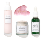 Four skincare products from Wild Rising arranged on a white background: a pale pink pump bottle labeled Canvas, a pink gua sha massage tool, a clear jar labeled Purify Botanical Face Mask, and a dark green dropper bottle labeled Moon Light Smoothing Serum