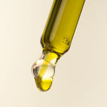 pipette with browny green hemp oil in