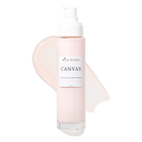 A bottle of Wild Rising Canvas Moisturizing Cream Cleanser with a white pump dispenser, set against a clean white background with a pale pink cream smear behind it.