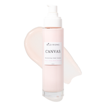 A bottle of Wild Rising Canvas Moisturizing Cream Cleanser with a white pump dispenser, set against a clean white background with a pale pink cream smear behind it.