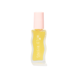 A small clear bottle filled with pale yellow liquid, featuring a light pink cap and vertical white text reading 'WILD RISING' on the front, centered on a plain white background.