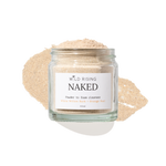 A clear glass jar labeled 'WILD RISING NAKED' containing a light beige powder, set against a white background with a matching beige powder smear behind it.