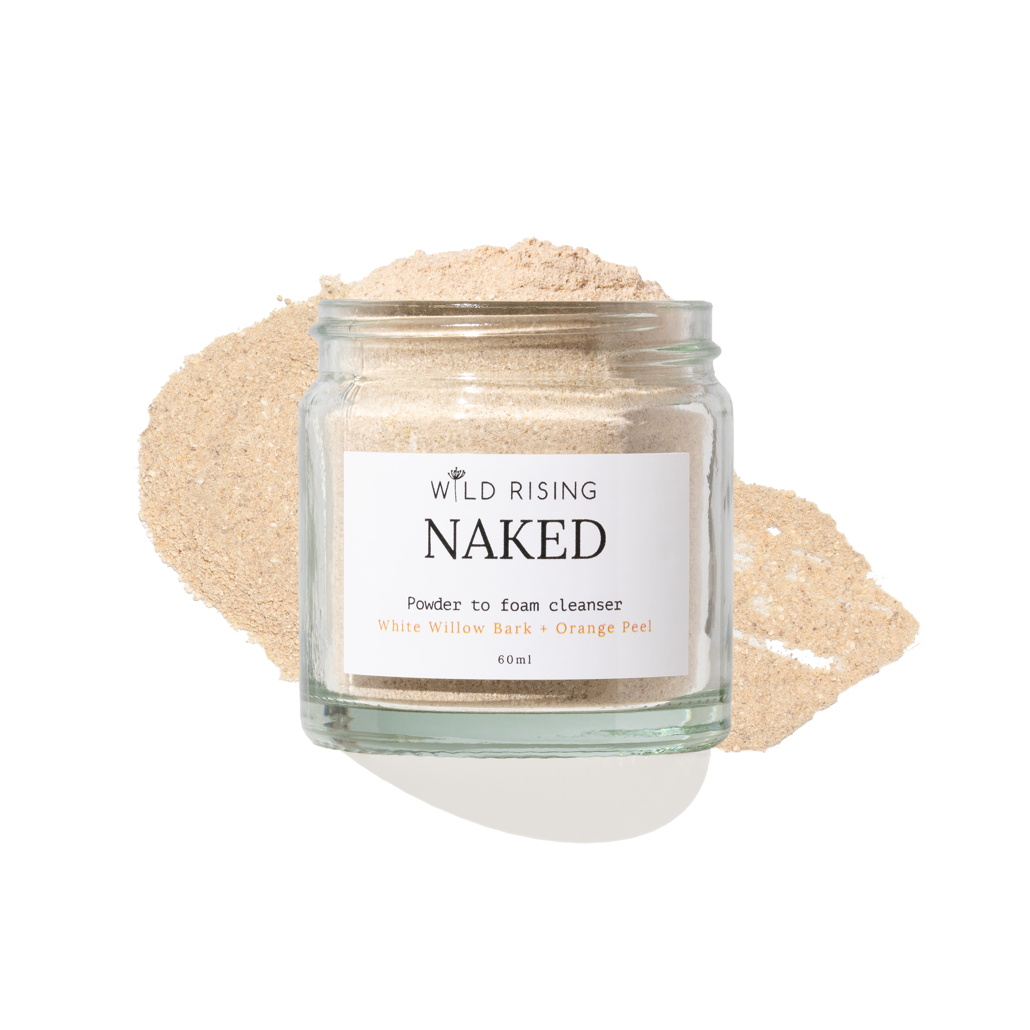 A clear glass jar labeled 'WILD RISING NAKED' containing a light beige powder, set against a white background with a matching beige powder smear behind it.