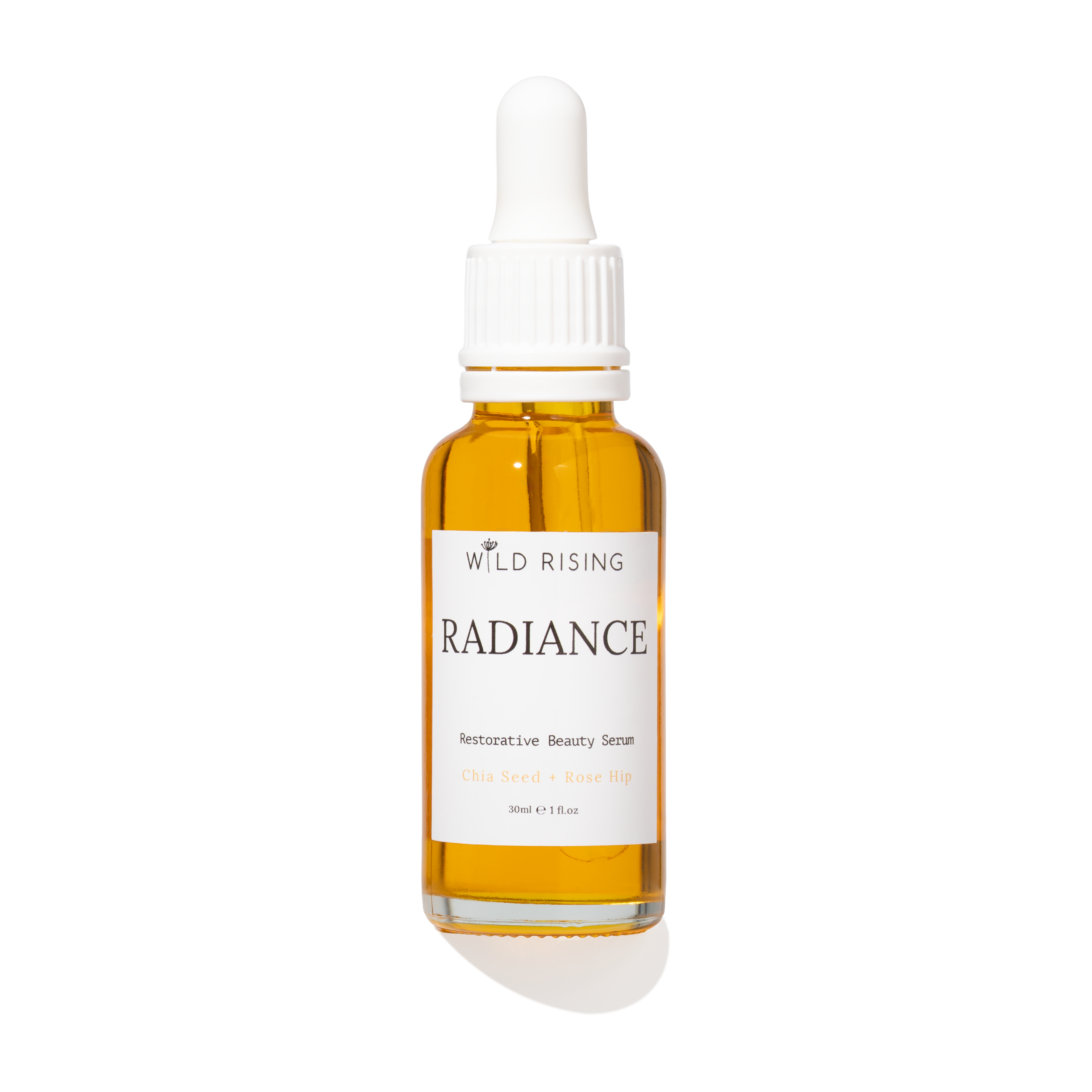 A 30ml glass dropper bottle of Wild Rising Radiance  Beauty Serum, filled with golden-yellow oil, featuring a white label and white dropper cap on a white background.