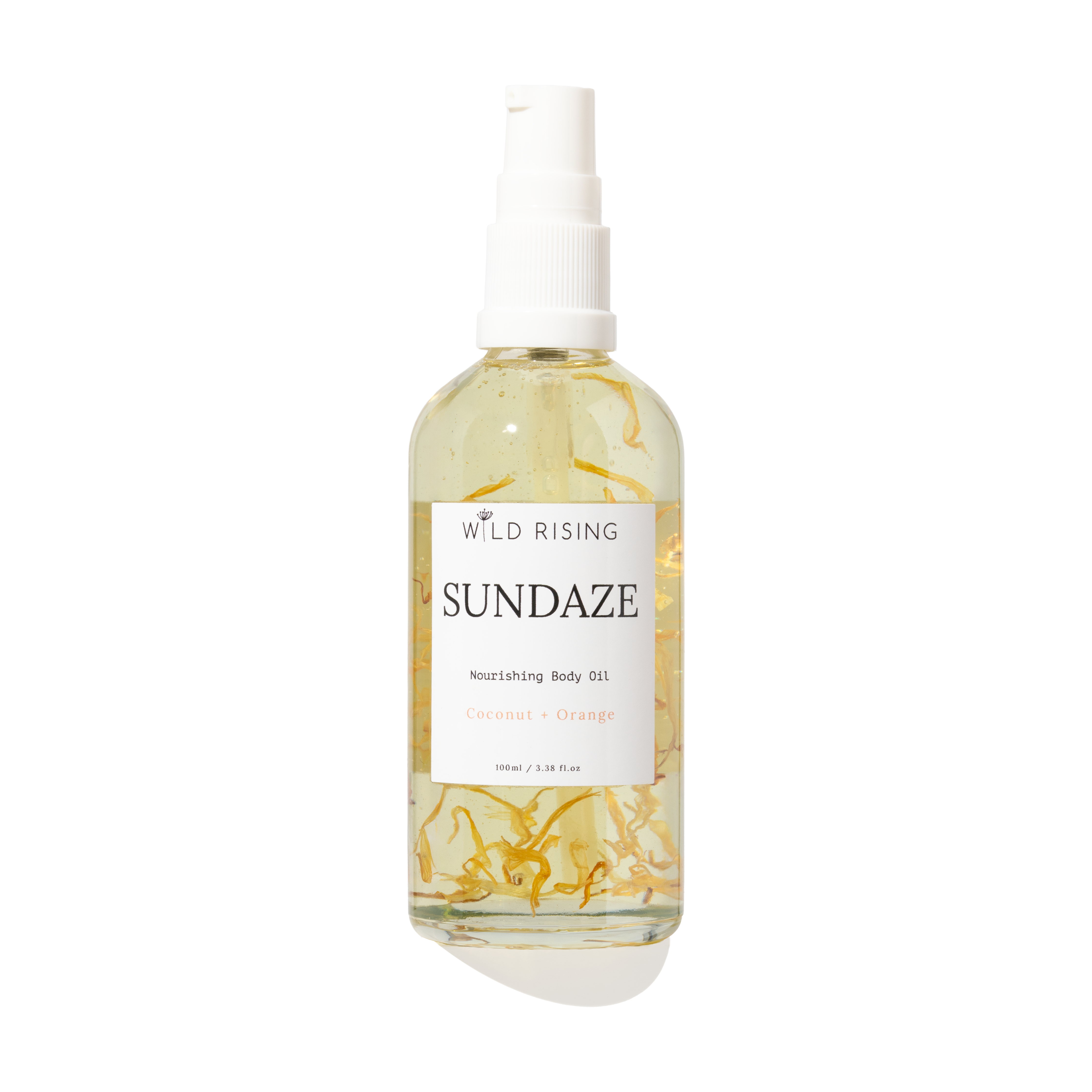 A 100ml spray bottle of Wild Rising Sundaze Coconut + Orange nourishing body oil, filled with pale yellow oil and suspended golden botanical pieces, set against a plain white background.