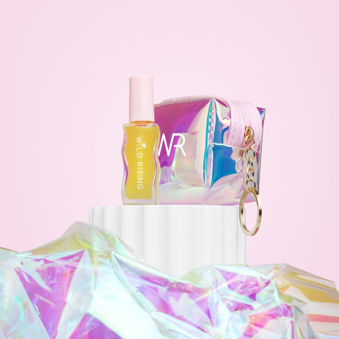 lip oil bottle with packaging and keychain on a colorful background