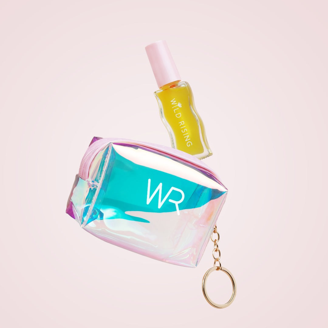 Iridescent coin purse with 'WR' branding and a small bottle on a light pink background