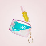 Iridescent coin purse with 'WR' branding and a small bottle on a light pink background