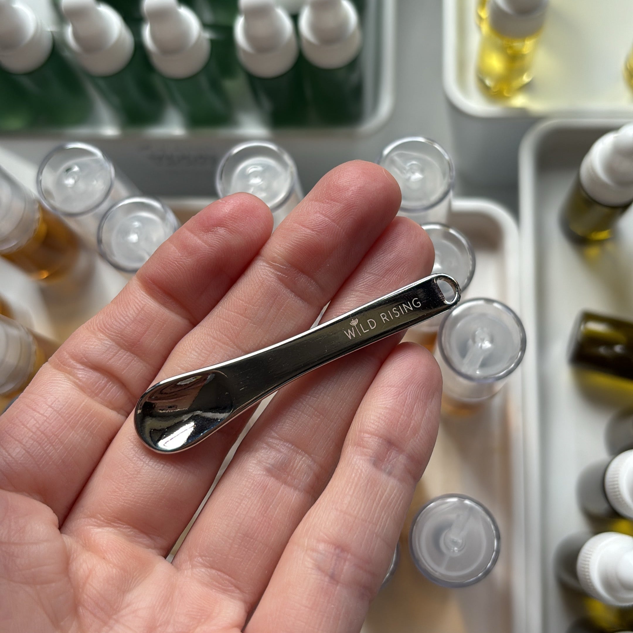 wild rising skincare spatula in hand