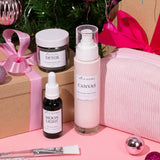 Cosmetic products with Christmas decorations and a gift box in the background