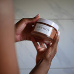 body polish jar being held in hands