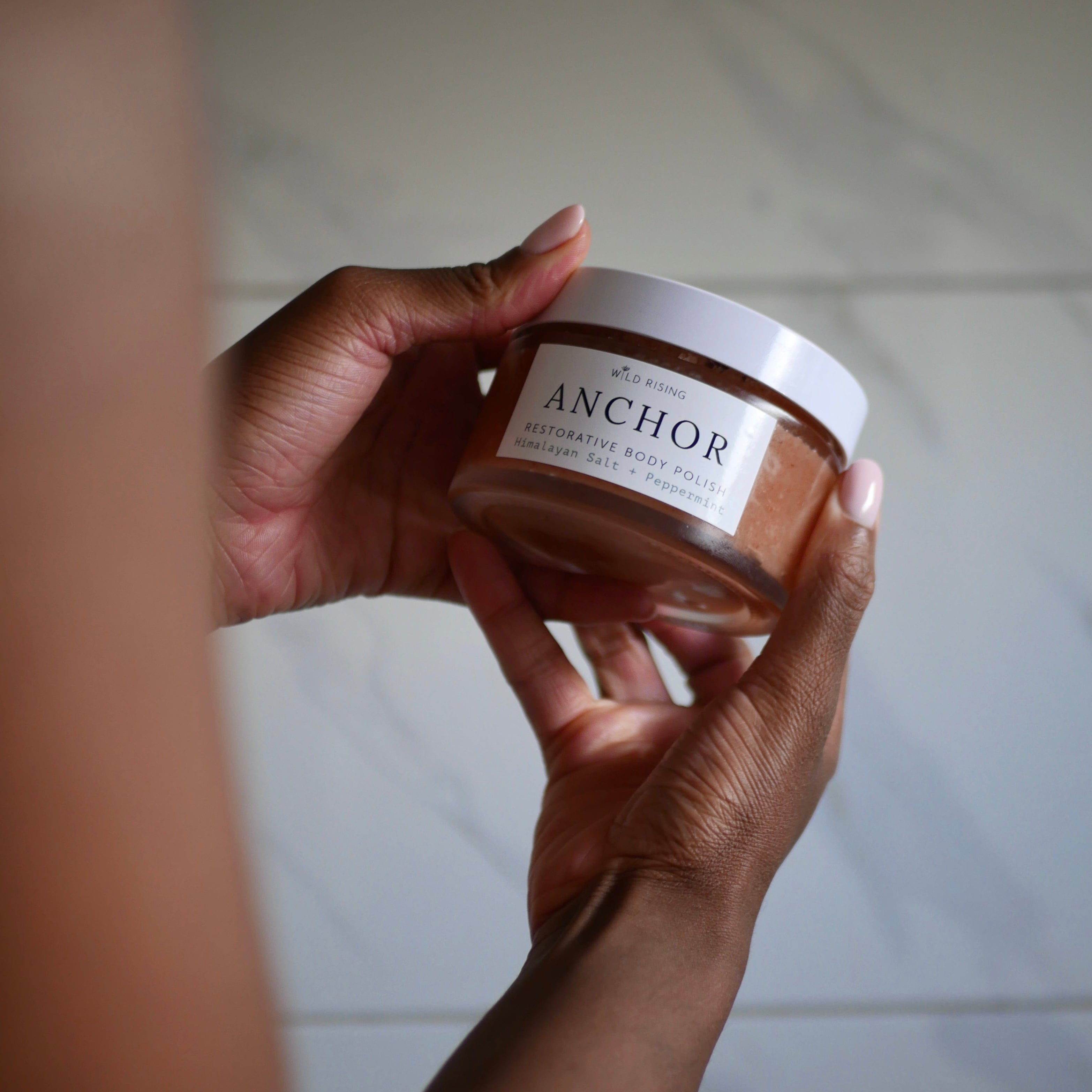 body polish jar being held in hands