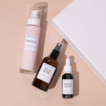 skincare gift box with three products set in beside it, cream background