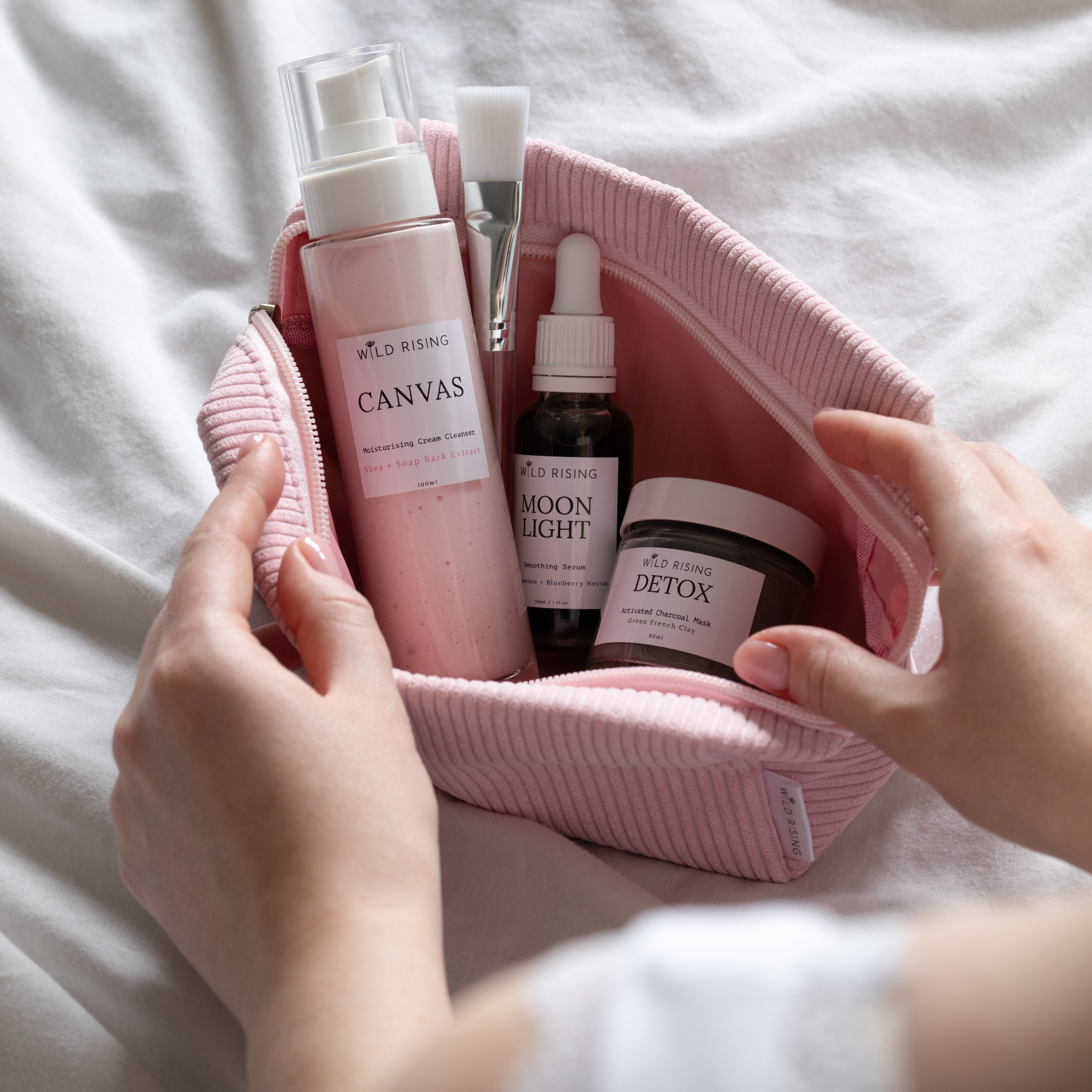skincare products in a pink corded bag
