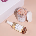 rose body oil and bath salts flatlay