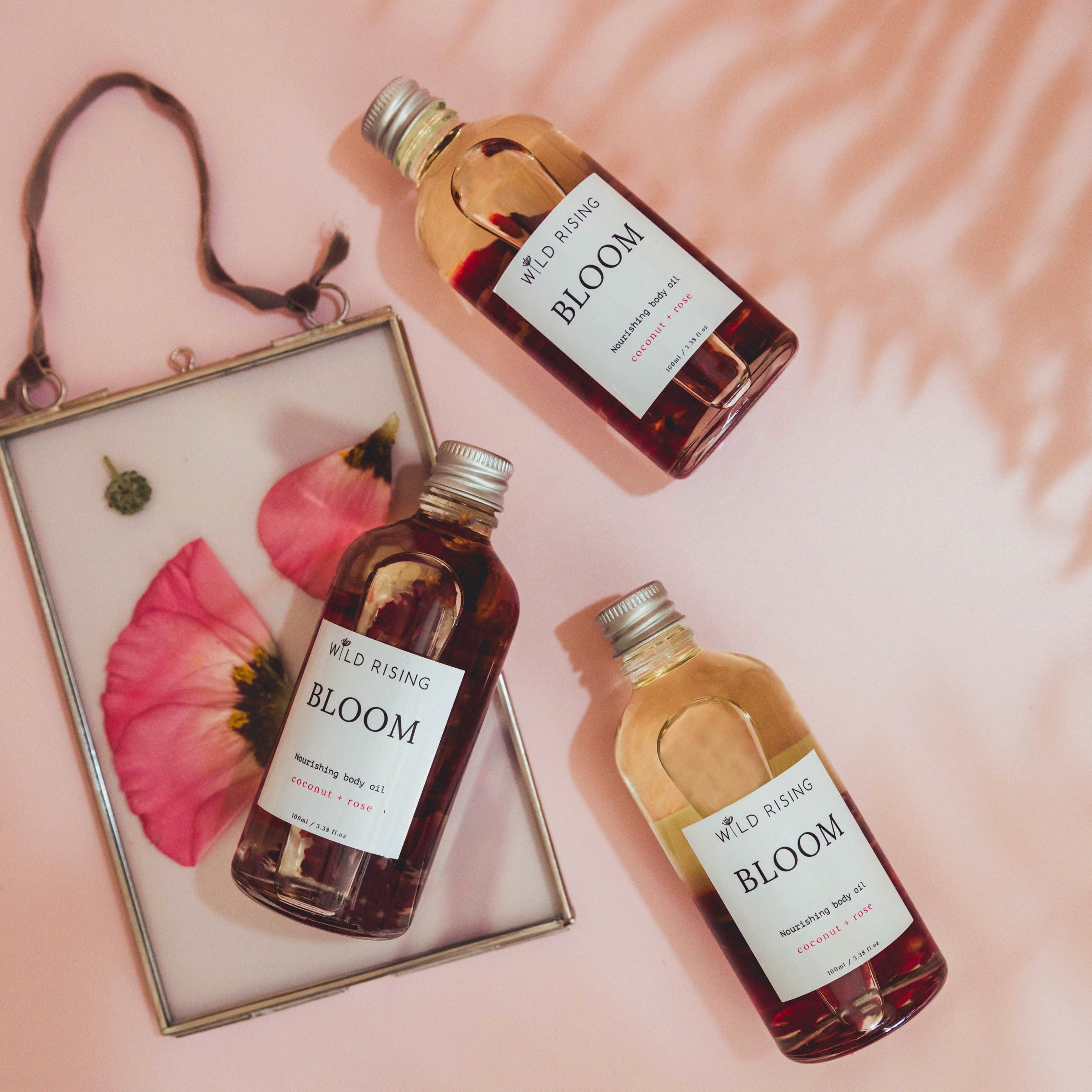 natural coconut and rose body and bath oil flat lay