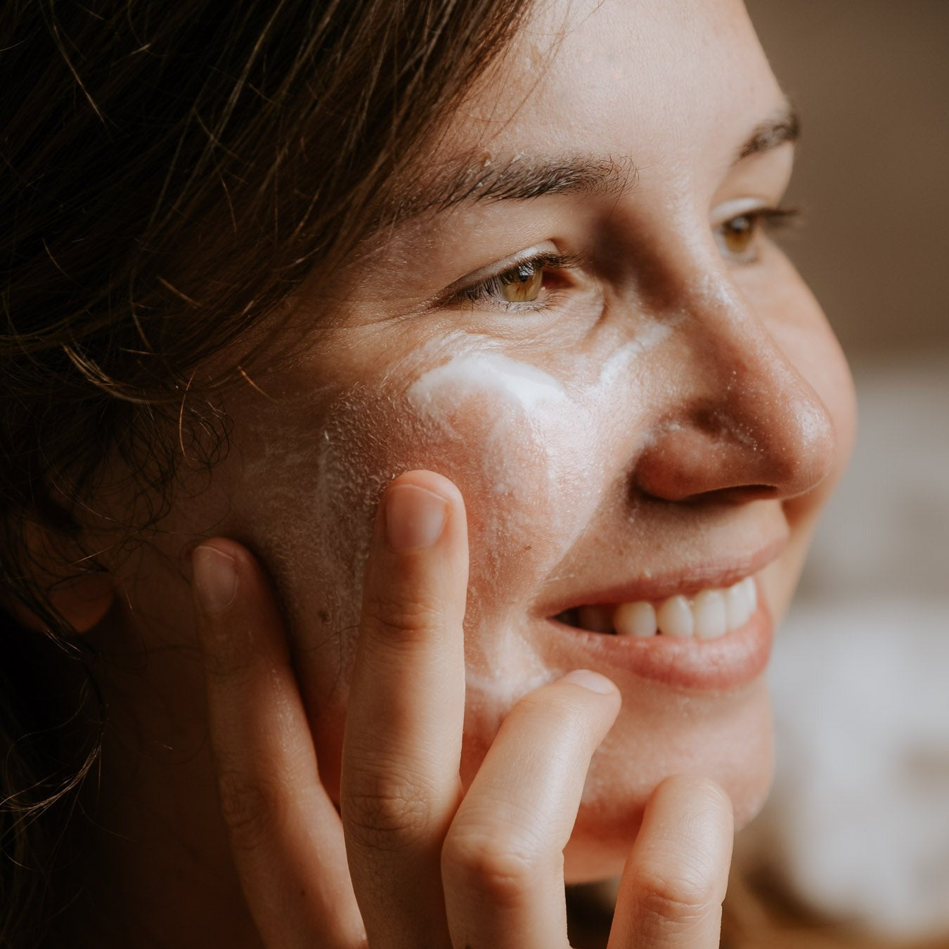 Model with canvas cream cleanser on her face