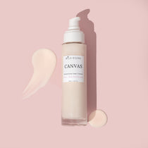 Canvas organic cream cleanser laid flat with smears around it