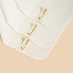 close up of wild rising muslin cleansing cloths showing tags