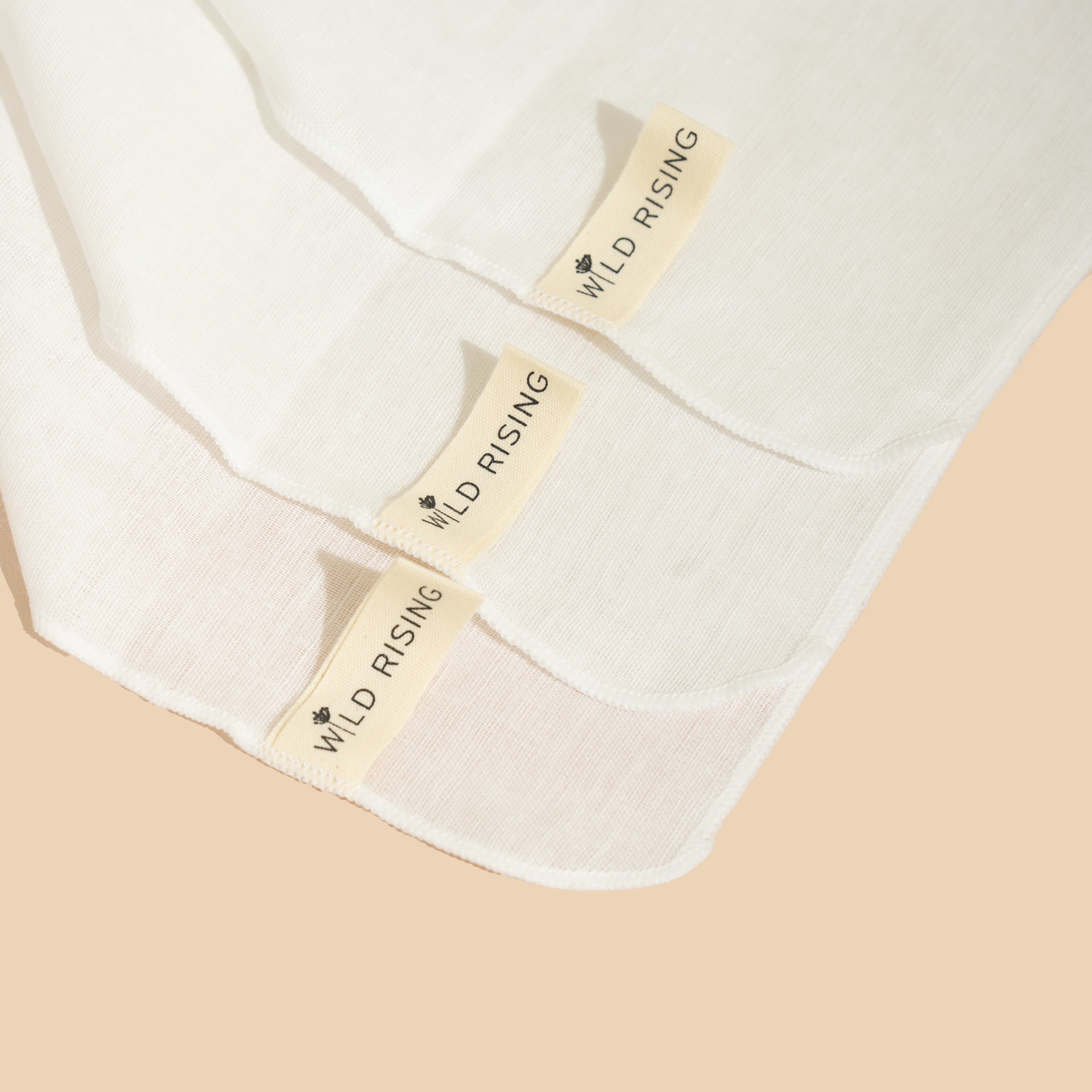 close up of wild rising muslin cleansing cloths showing tags