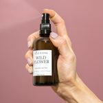 wild rising wild flower rose water witch witch hazel toner being sprayed in hand