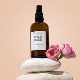 wild rose organic rosewater toner balanced on pebble