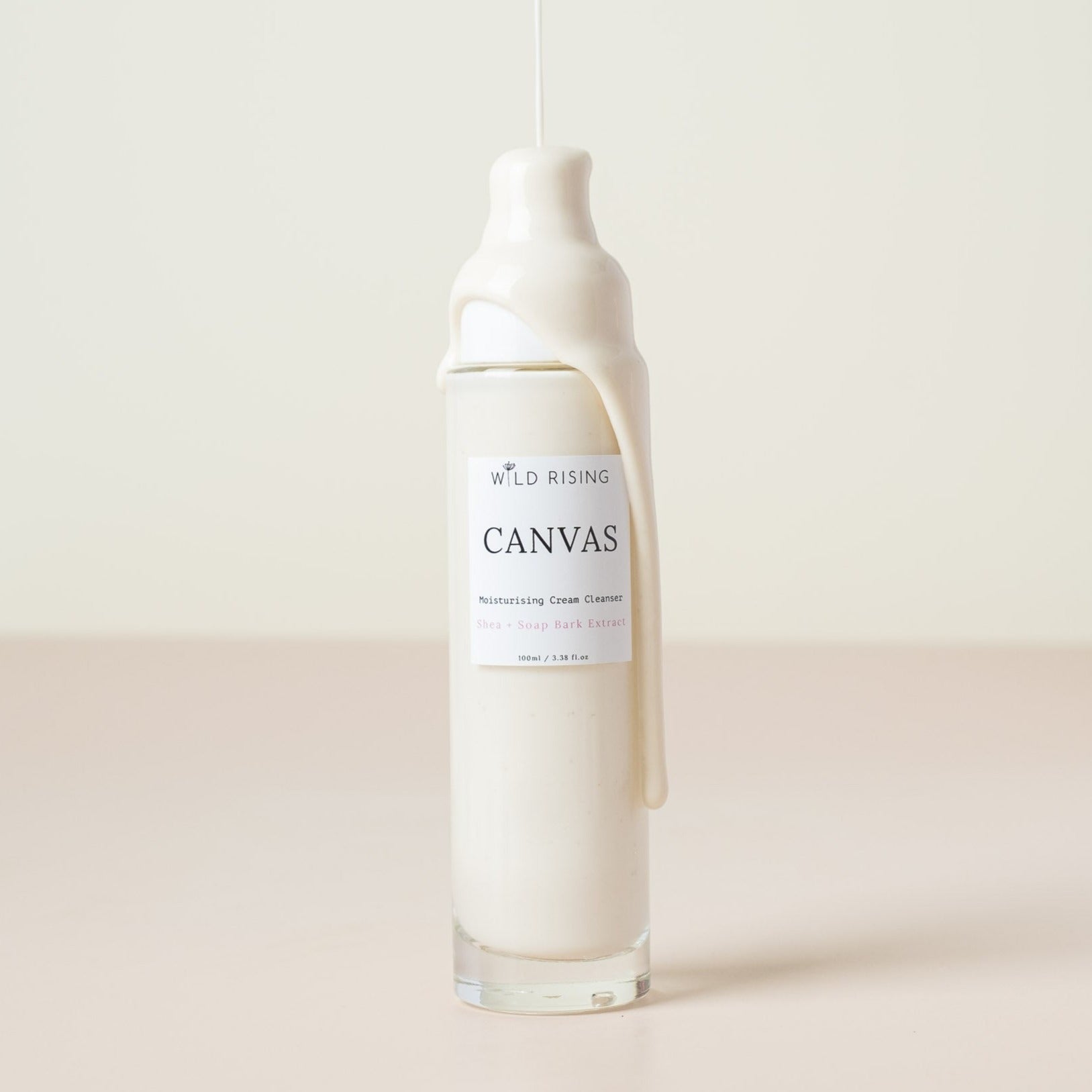 canvas cream cleanser with cream dripping down the bottle