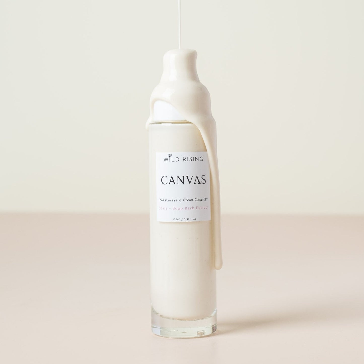 canvas cream cleanser with cream dripping down the bottle